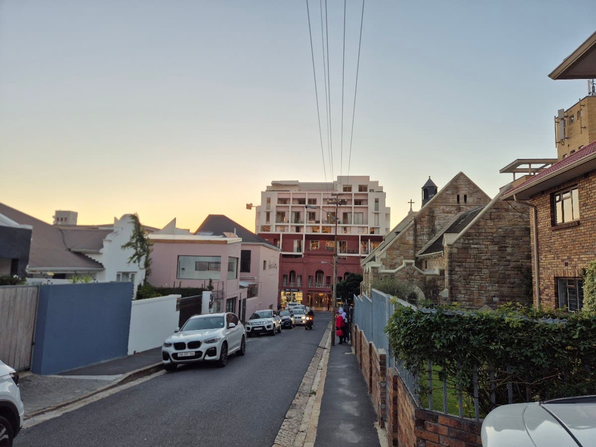 A city street at dusk lined with historic buildings
