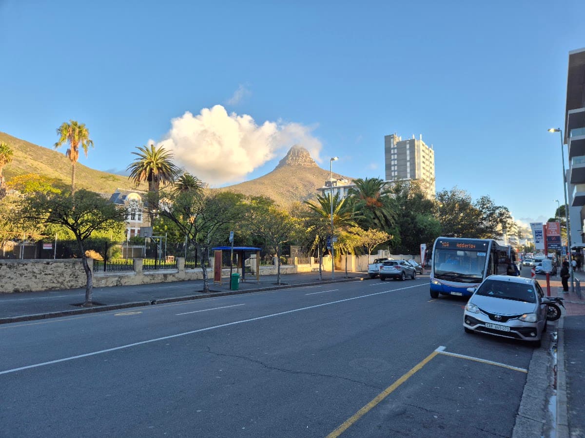 A main road with traffic and a mountain backdrop