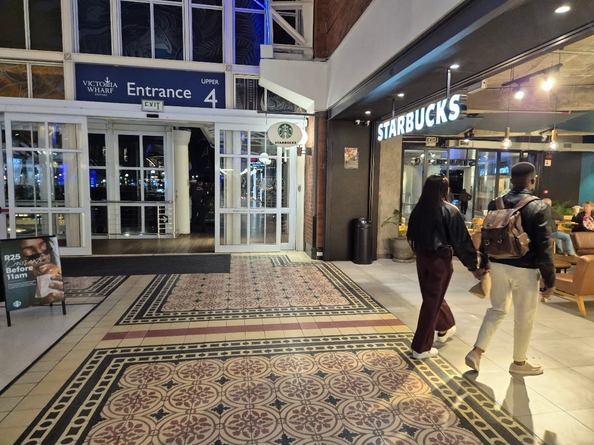 The entrance to a shopping mall with a Starbucks storefront